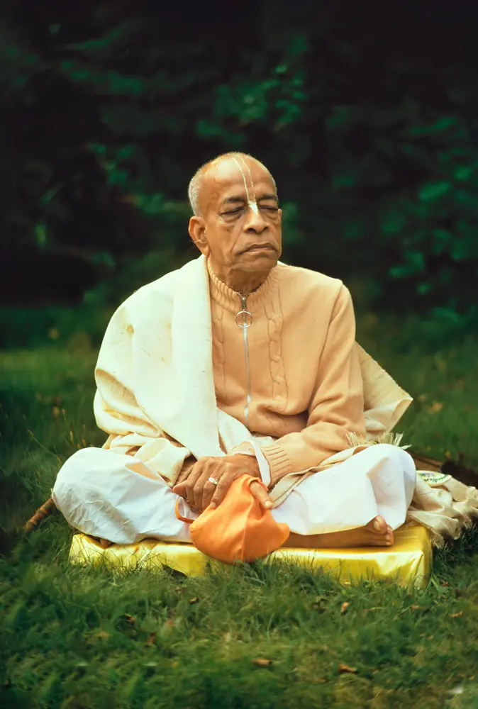 Prabhupada Chanting Japa on Yellow Cushion on Grass