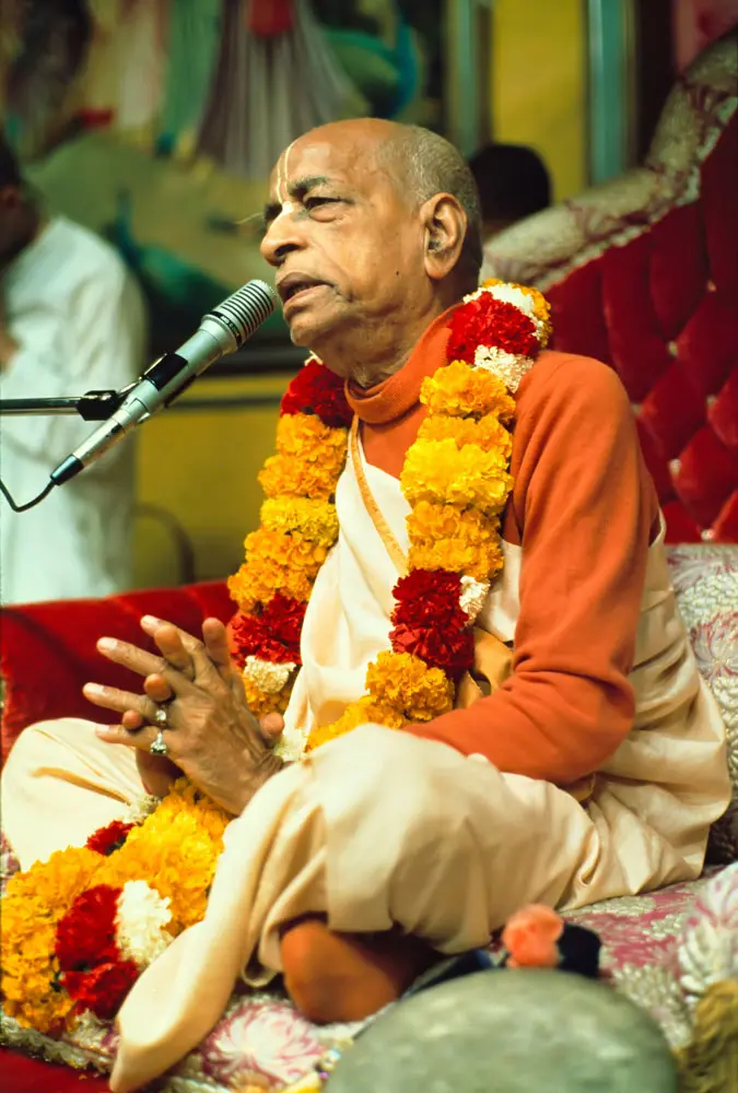 Prabhupada Giving Class in Los Angeles New Dwarka Temple with Folded Hands on Red Vyasasana