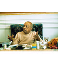 Prabhupada Sitting at Desk Explaining Philosophy to Guests