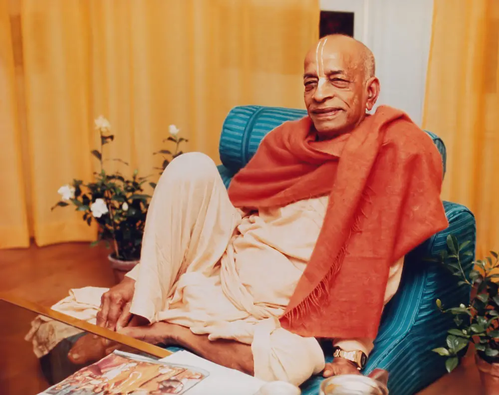 Srila Prabhupada Sitting Relaxed on Blue Seat