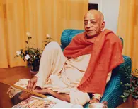 Srila Prabhupada Sitting Relaxed on Blue Seat